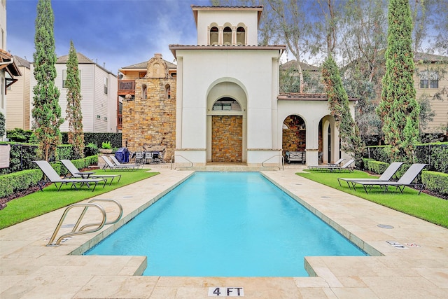 rear view of house featuring a patio and a community pool