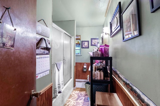 corridor with wainscoting and wood walls