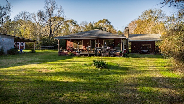 rear view of house with a porch, a yard, and a carport