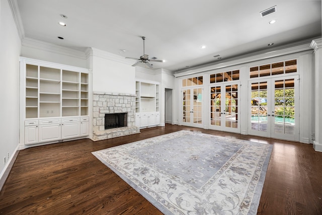 living room with ceiling fan, french doors, dark hardwood / wood-style floors, a fireplace, and ornamental molding