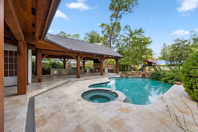 view of swimming pool with a gazebo, a patio area, an in ground hot tub, and area for grilling