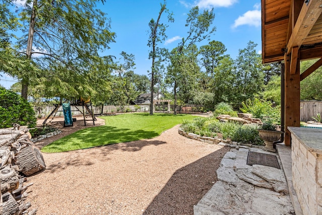 view of yard featuring a playground and a patio