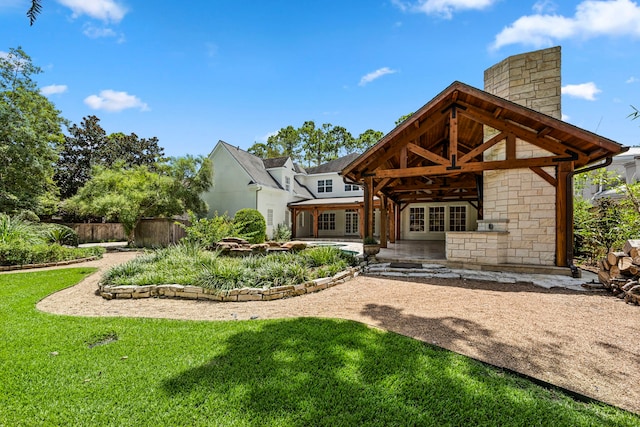 back of house featuring french doors, a yard, and a patio area