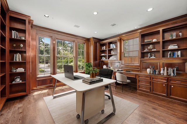 office space featuring wood-type flooring and wood walls