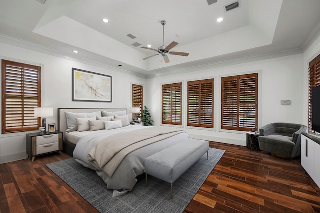 bedroom with ceiling fan, dark hardwood / wood-style floors, a raised ceiling, and ornamental molding