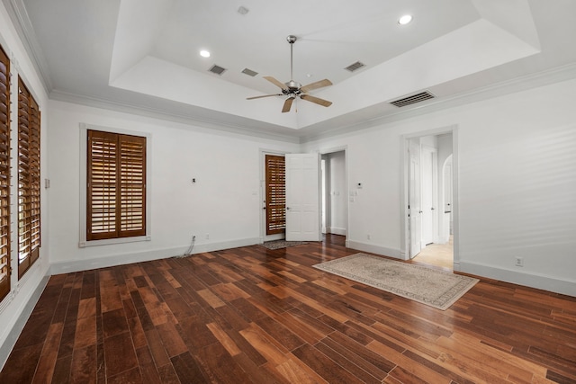 spare room with a raised ceiling, ceiling fan, dark hardwood / wood-style floors, and ornamental molding