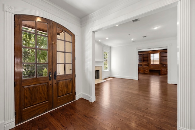 foyer featuring plenty of natural light, dark hardwood / wood-style floors, french doors, and ornamental molding