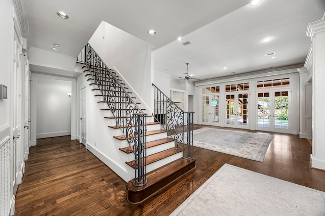 stairs featuring ceiling fan, wood-type flooring, ornamental molding, and french doors