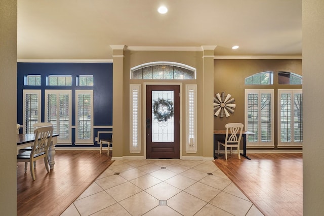 entrance foyer featuring light tile patterned floors and ornamental molding