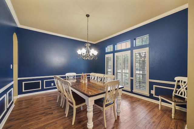 dining space with a notable chandelier, ornamental molding, and dark wood-type flooring