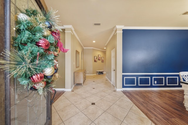 tiled foyer entrance featuring ornamental molding