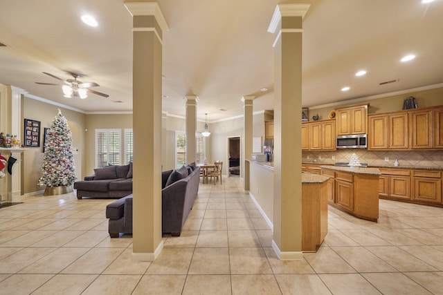 kitchen featuring ceiling fan with notable chandelier, light tile patterned floors, and ornamental molding