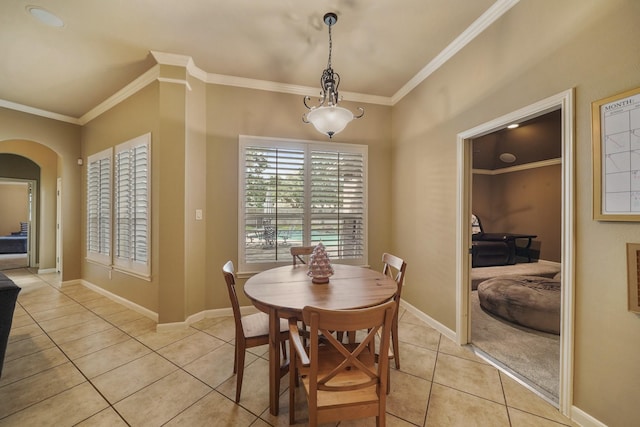 dining space featuring crown molding and light tile patterned flooring