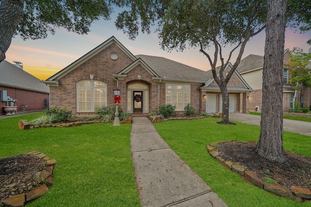 ranch-style house with a lawn and a garage