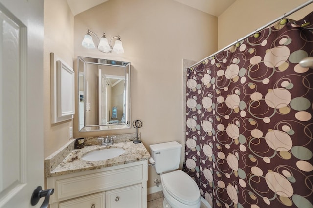 bathroom featuring tile patterned floors, vanity, and toilet