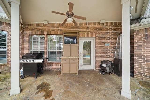 view of patio with ceiling fan and area for grilling