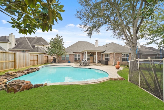 view of pool featuring a patio area and a yard