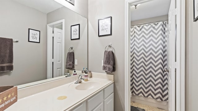 bathroom featuring vanity and curtained shower