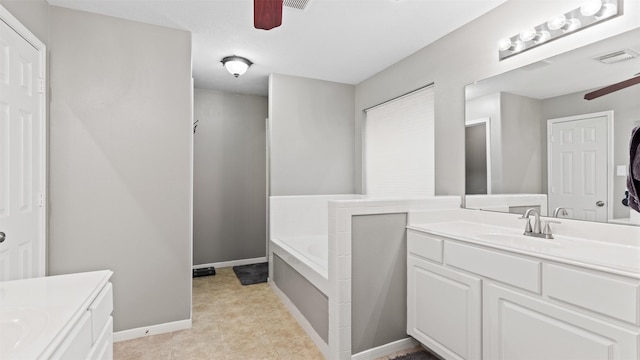 bathroom featuring vanity, a bathtub, and ceiling fan