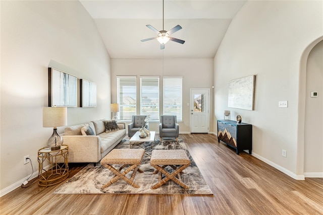 living room featuring hardwood / wood-style flooring, vaulted ceiling, and ceiling fan