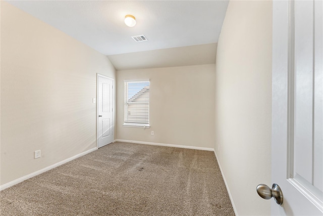 unfurnished room with lofted ceiling and carpet floors