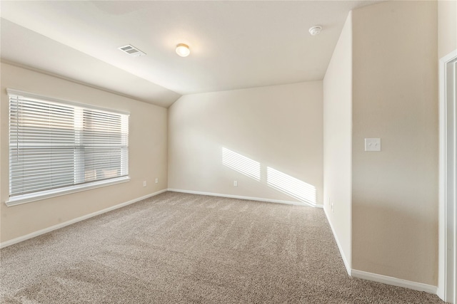 unfurnished room featuring carpet floors and vaulted ceiling