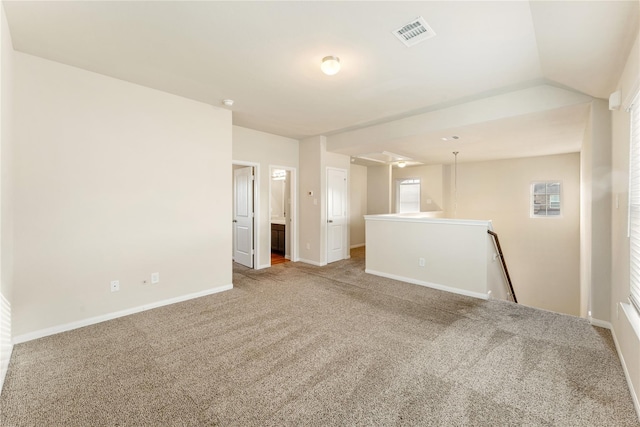 unfurnished room featuring carpet floors and lofted ceiling