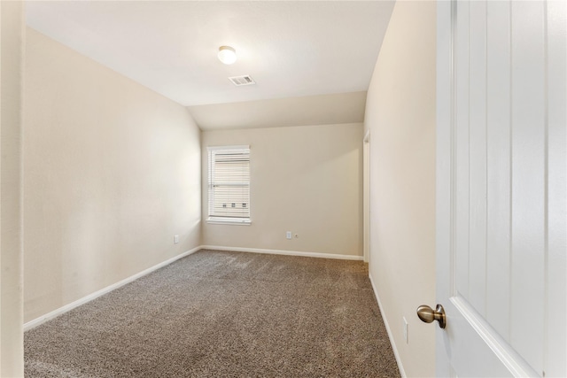 unfurnished room featuring carpet floors and lofted ceiling