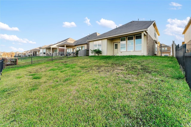 rear view of house featuring a lawn