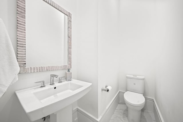 bathroom featuring sink and toilet