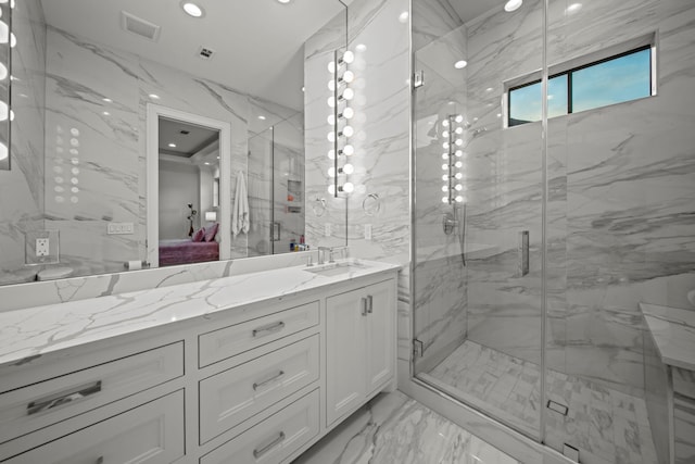 bathroom featuring vanity and a shower with door