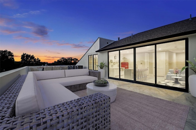 patio terrace at dusk featuring an outdoor living space