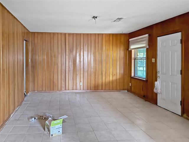 empty room featuring wood walls