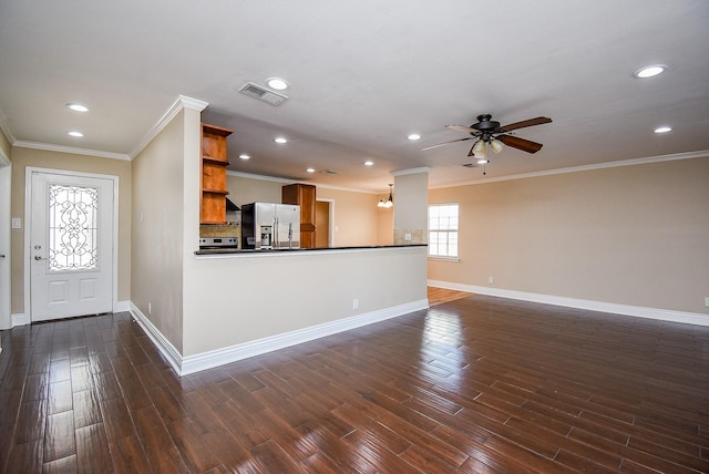 interior space featuring stainless steel fridge, ornamental molding, dark hardwood / wood-style floors, and ceiling fan