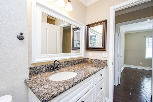 bathroom with crown molding and vanity