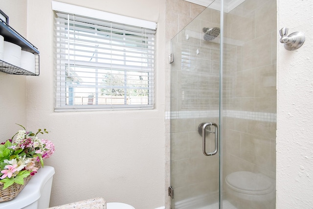 bathroom with an enclosed shower, ornamental molding, and toilet