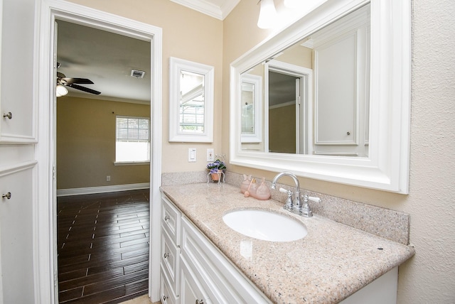 bathroom with ornamental molding, vanity, and ceiling fan