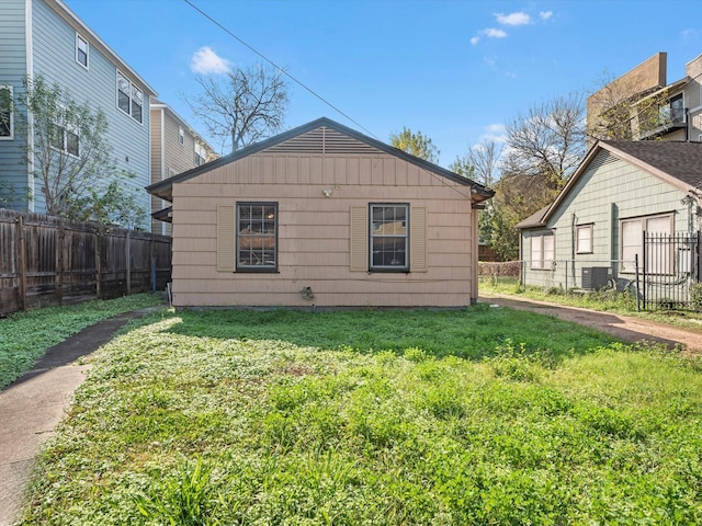 view of property exterior featuring a yard and central air condition unit