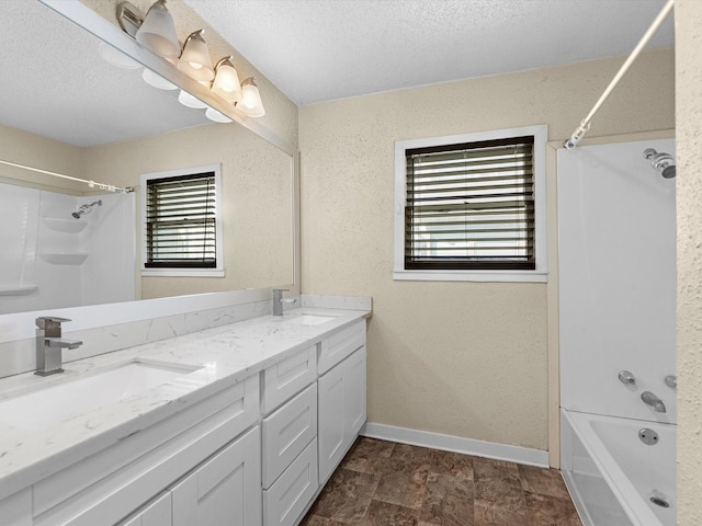 bathroom featuring vanity, shower / bath combination, and a textured ceiling