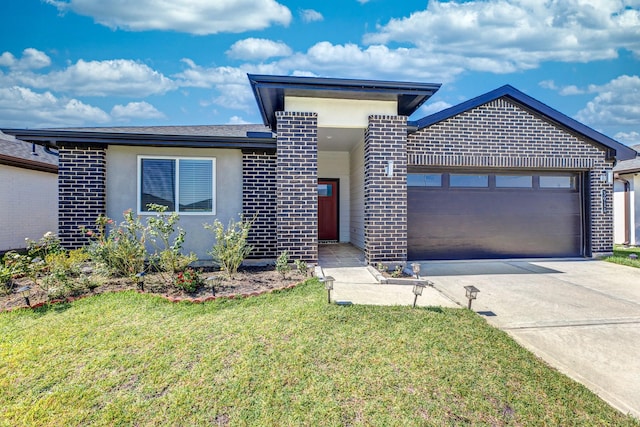 view of front of home featuring a front yard and a garage