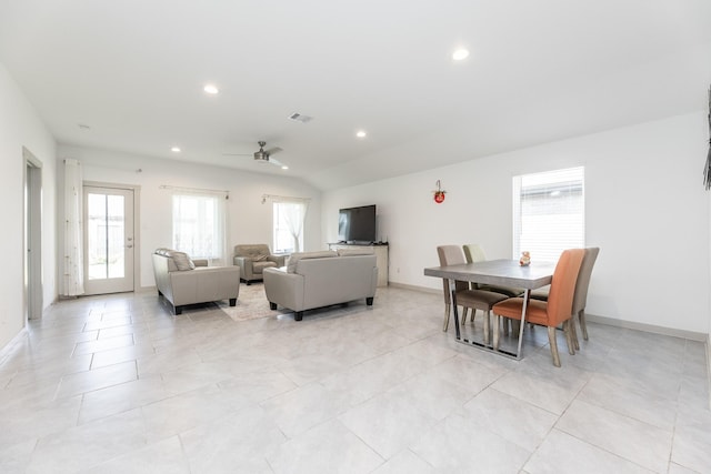 living room featuring lofted ceiling, ceiling fan, and a healthy amount of sunlight