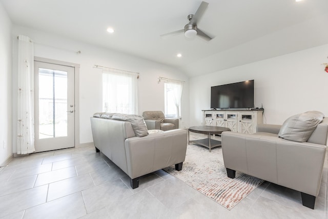 living room featuring light tile patterned floors, vaulted ceiling, ceiling fan, and a healthy amount of sunlight