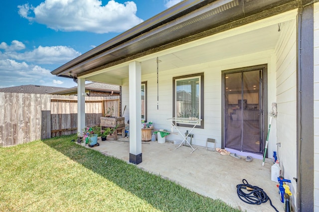 doorway to property featuring a patio area and a yard