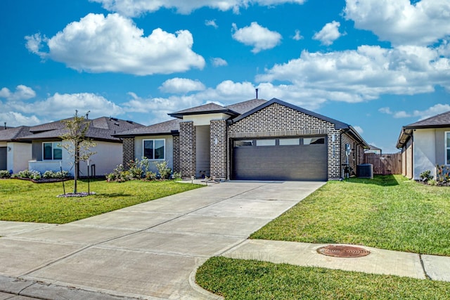 view of front of house featuring a front lawn, central AC unit, and a garage