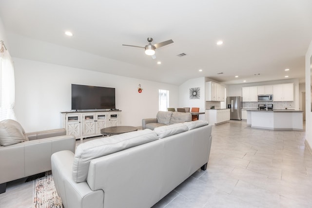 living room featuring ceiling fan and vaulted ceiling