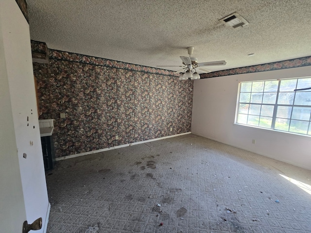 spare room featuring a textured ceiling and ceiling fan