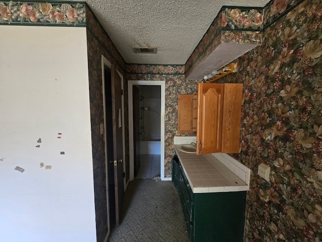 hallway with a textured ceiling