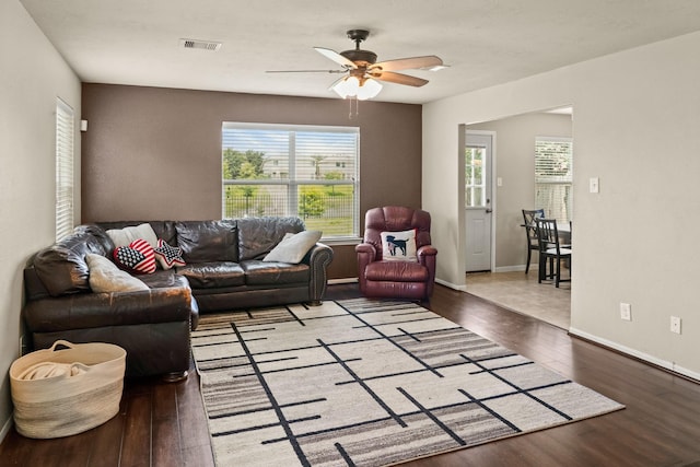 living room featuring wood-type flooring and ceiling fan