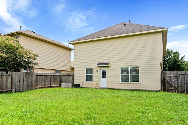 rear view of property with a lawn