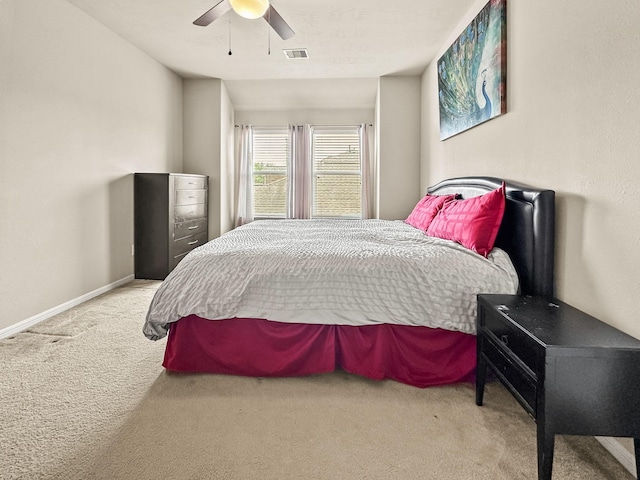 bedroom with ceiling fan and light colored carpet